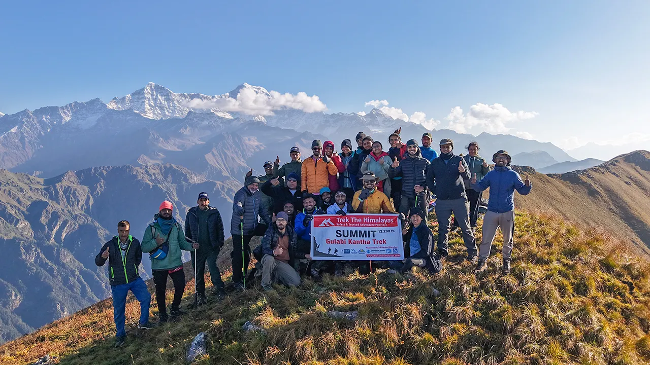 Trekkers enjoying the view of Gulabi Kantha Trek summit at 13,200 ft with Trek The Himalayas