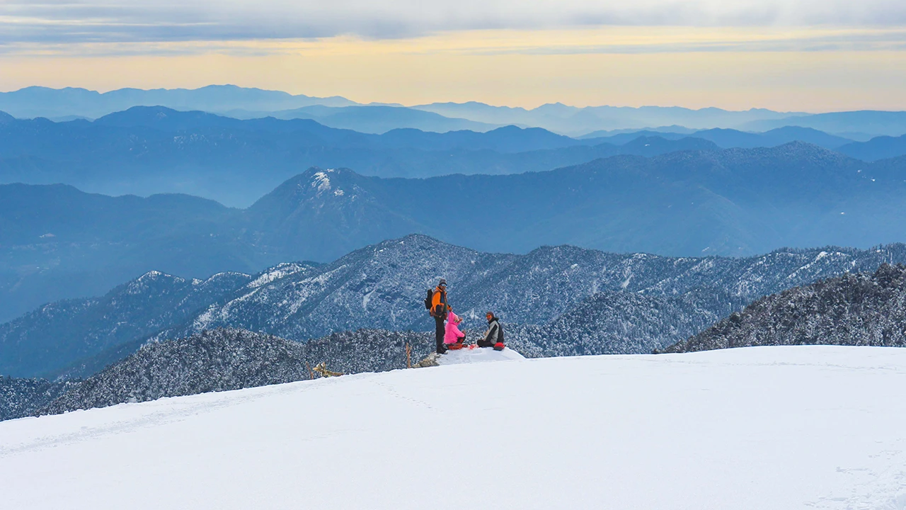 Trekkers enjoying snowy mountain views during the Brahmatal Trek 