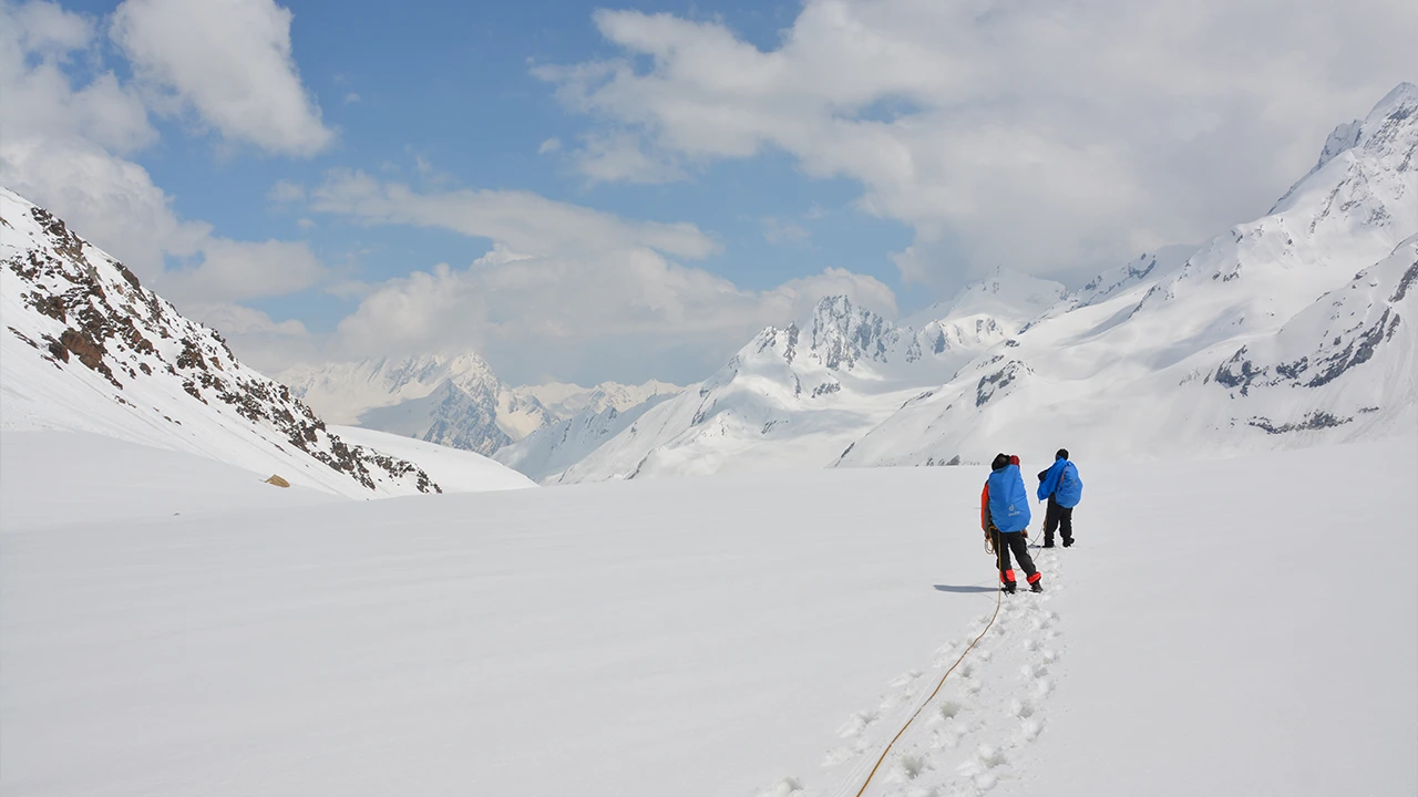 Trekkers hiking uphill on an easy mountain expedition.