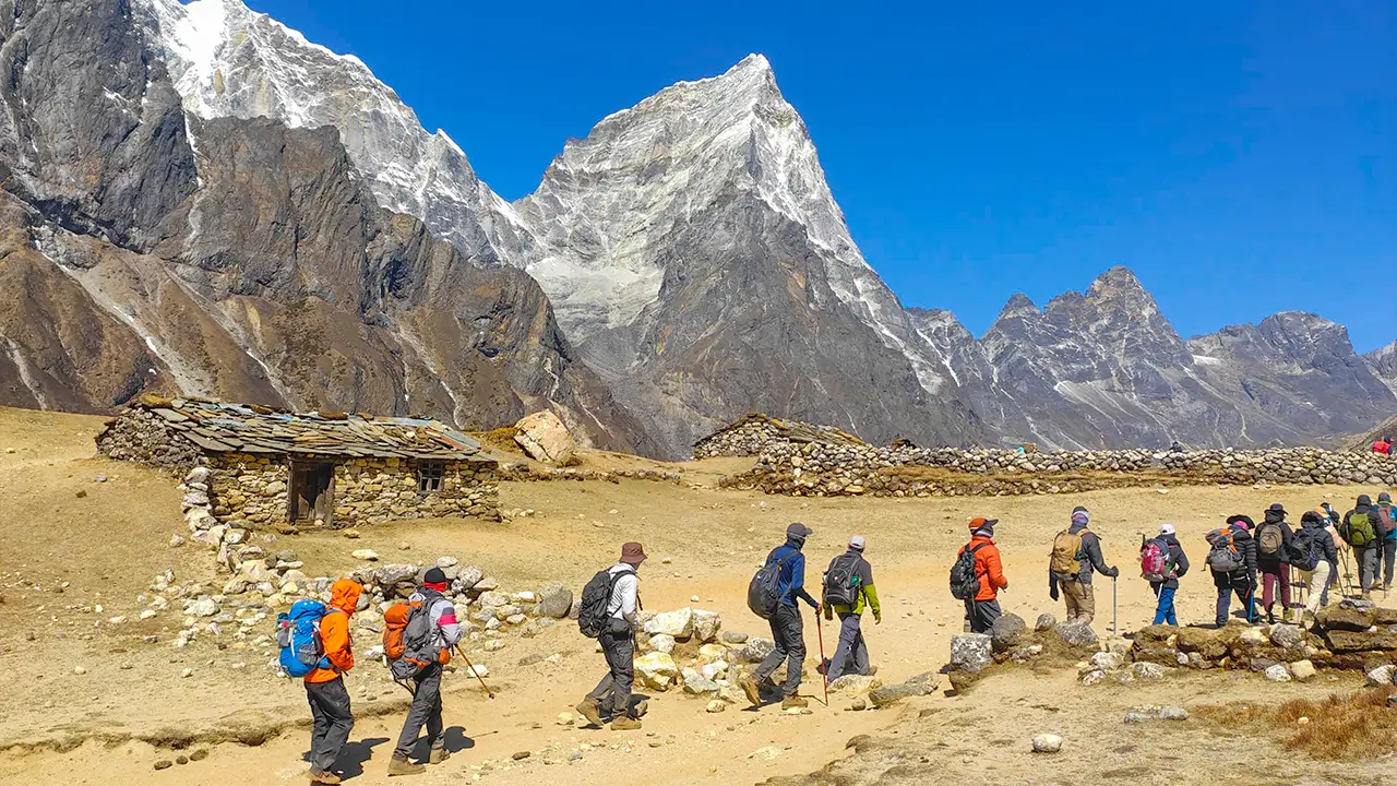 People walking on the trails of Indian Hikes, trekking through the picturesque Himalayan landscape, Trek The Himalayas